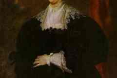 portrait-of-a-lady-dressed-in-black-before-a-red-curtain