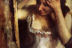 woman-combing-her-hair-in-front-of-a-mirror